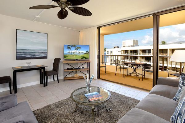 Modern new living room with comfortable furniture and flatscreen TV.