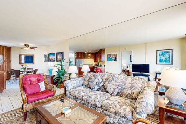 Spacious Living Area with Mirrored Wall & Tropical Decor