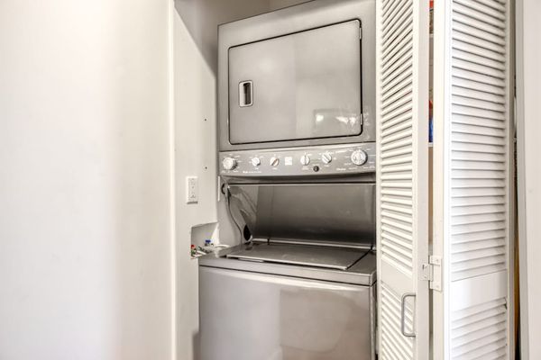 Stacked Washer and Dryer Unit Tucked into Closet Space