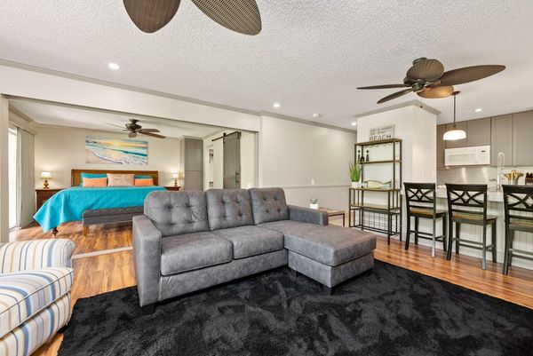 Spacious living room offers sectional seating beside the dining area