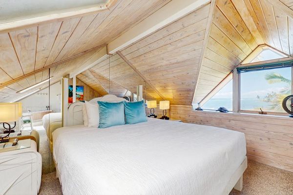 Retreat to the cozy loft bedroom with a comfortable king bed and warm wood interiors.