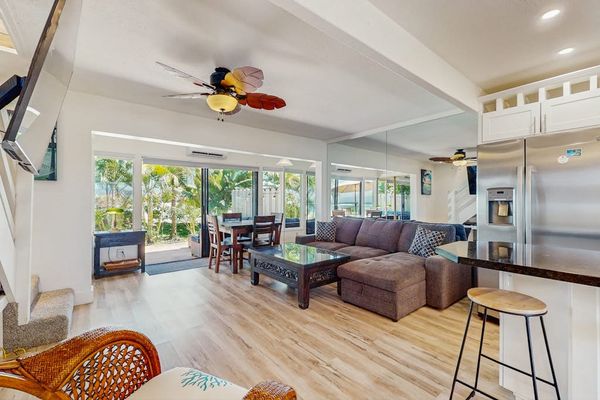 The bright open-concept living room is perfect for relaxing and gathering together.