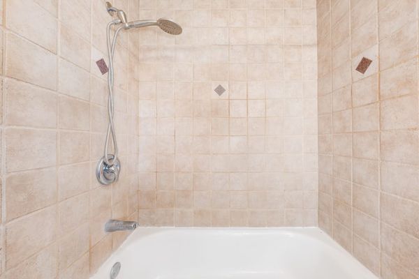 Walk-in shower with neutral tile finishes
