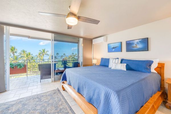 Master bedroom with king bed and balcony access