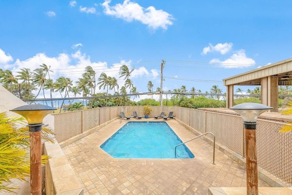 Relaxing pool area with sun loungers and ocean breeze