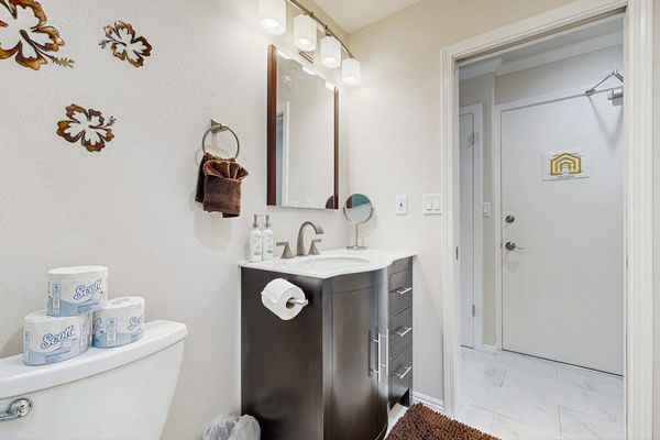 Bathroom vanity displays mirror storage baskets and decorative floral accents