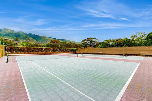 Tennis court offers open-air recreation with scenic island mountain views