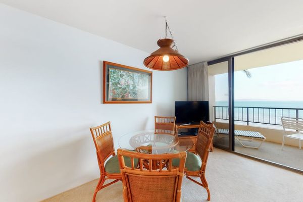 Dining room table with seating for four with views of the ocean through the lanai.
