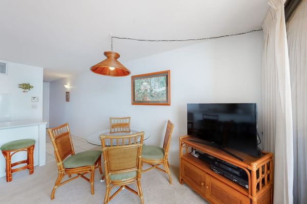 Dining room table with seating for four with views of the ocean through the lanai.