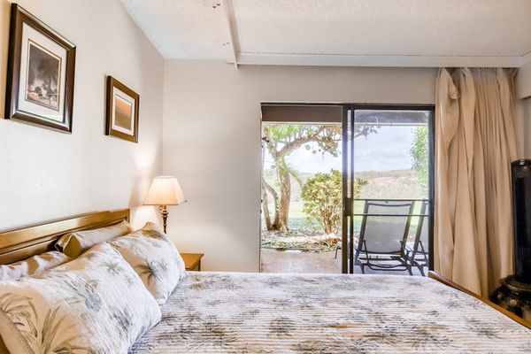 Bedroom seating area provides relaxing views across tropical resort grounds