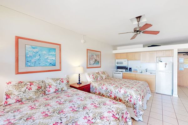 Comfortable studio sleeping area features double beds and ceiling fans