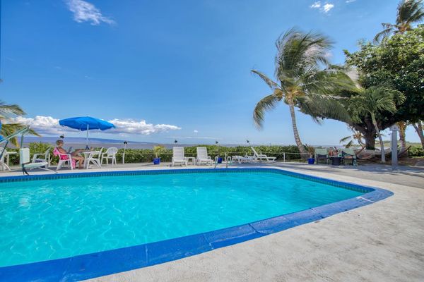 Resort pool offers refreshing swims beside beautiful tropical island scenery