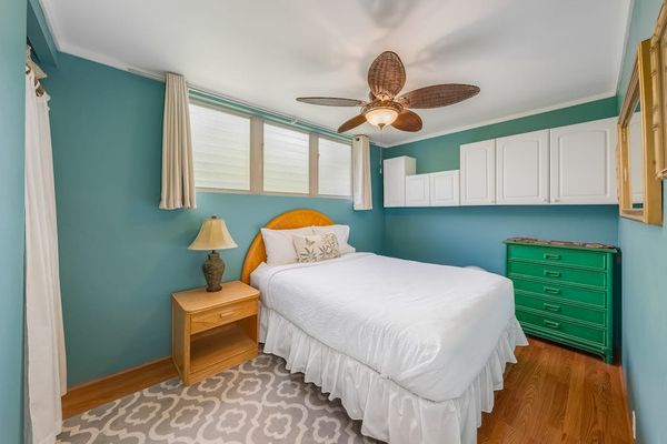 Peaceful bedroom with ceiling fan provides a refreshing setting for restful vacation nights