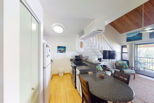 Bright kitchen features appliances counters and convenient meal preparation space