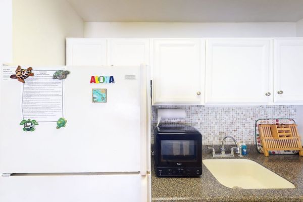 Enjoy cooking in this kitchen featuring a large refrigerator and practical modern amenities