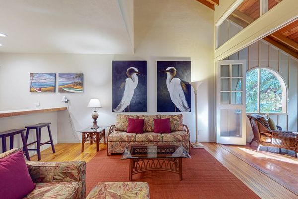 Open living room features expansive glass walls creating bright inviting indoor surroundings throughout