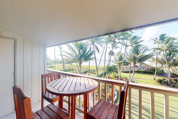 Lush resort grounds feature palms pathways and scenic island views