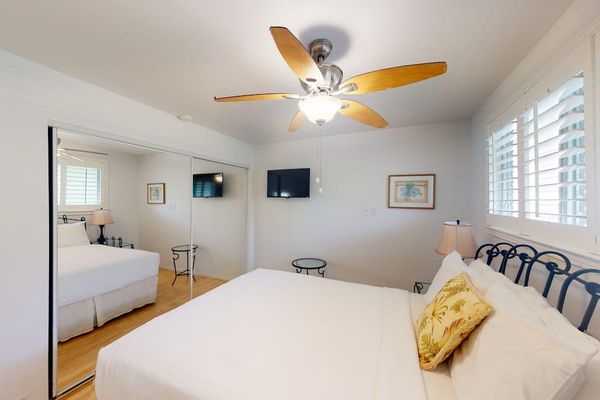 Comfortable bedroom offers a ceiling fan and welcoming space for peaceful sleep daily