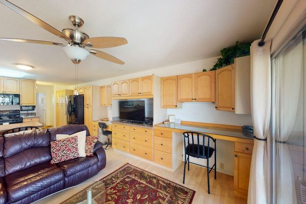 Living area and kitchen offer comfortable seating with island dining
