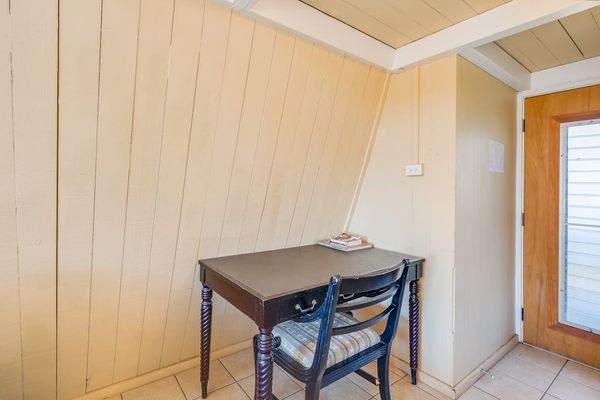 Dining nook offers a compact table beside wood paneling