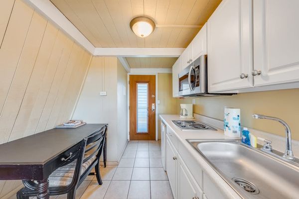 Kitchen counters and cabinets create an efficient studio cooking area