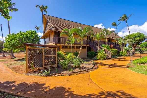 Resort cottage exterior welcomes guests with palms paths and sunshine