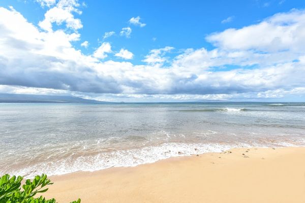 Crystal-clear turquoise waters gently wash onto pristine white sandy beaches.