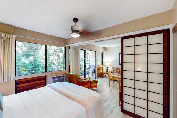 Bedroom with queen size bed and en suite.  Bedroom is separated from living space with a sliding divider, allowing for privacy or a more open concept feel.