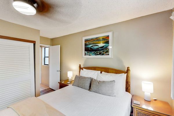 Bedroom with queen size bed and en suite.  Bedroom is separated from living space with a sliding divider, allowing for privacy or a more open concept feel.