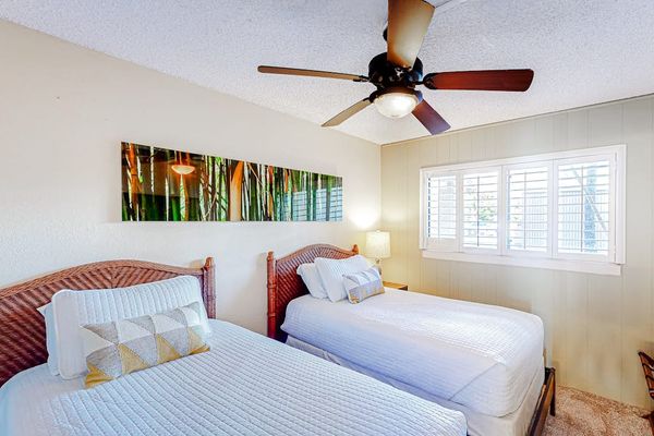 Guest room with two twin beds and a ceiling fan for your comfortable all night long.