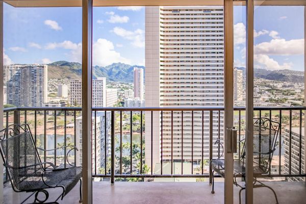 Private balcony with seating offers beautiful Waikiki skyline and mountain views, perfect for morning coffee or evening relaxation.