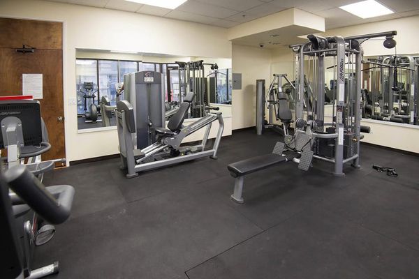 Stay on top of your exercise routine in the building's fully equipped fitness center, offering a variety of weight training machines, a workout bench, and mirrored walls.