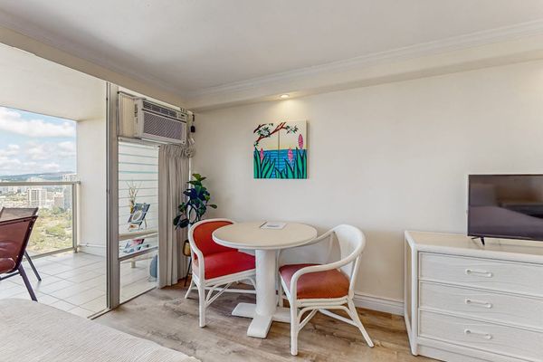 Designed for convenience, the studio layout includes a two-person dining nook, a flat-screen TV, and an air conditioning unit.