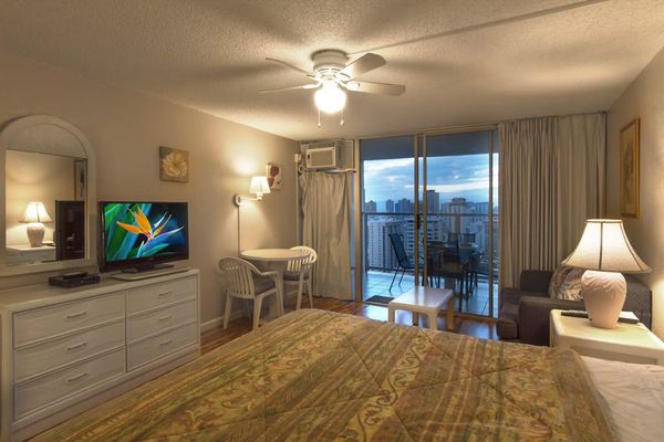Relax in this inviting studio featuring a comfortable king bed and convenient access to a private balcony.