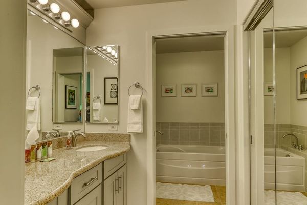 Relax and refresh in a private master bathroom featuring both a bathtub and shower for your comfort.