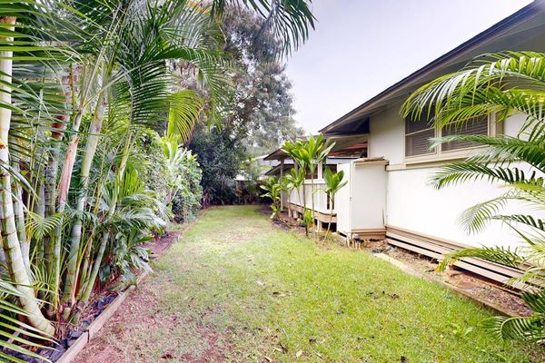Enjoy peaceful moments in the backyard framed by lush natural greenery everywhere