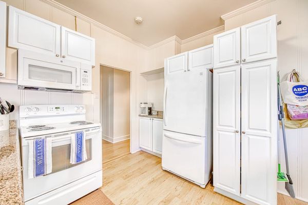Open kitchen offers generous counters and easy dining room access