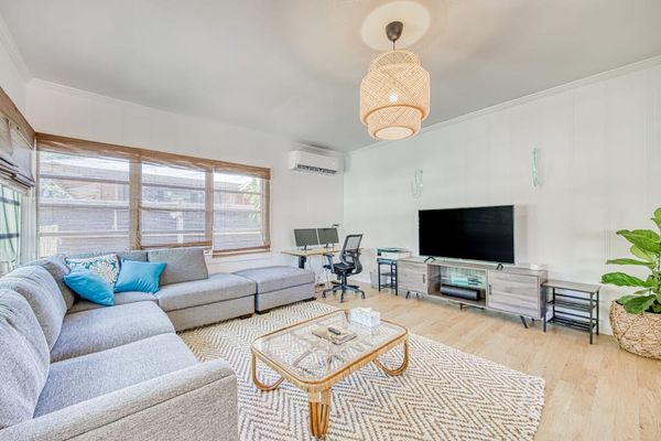 Unwind in the sunlit living room with plush sectional seating