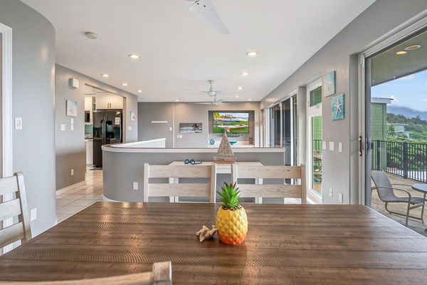 Bright, open-concept living with floor-to-ceiling doors that seamlessly blend indoor comfort with stunning tropical ocean views