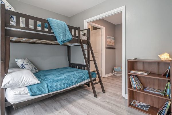 Rest easy in this quiet sleeping retreat featuring Queen over Queen bunk