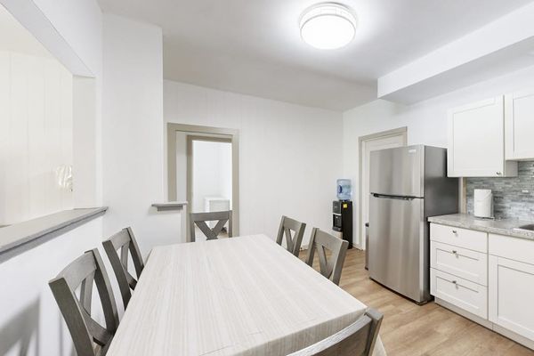 Gather around the dining table and prepare your favorite meals in this open and functional space.