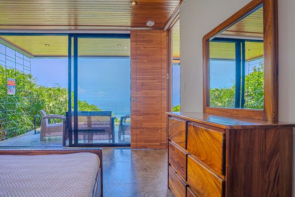 Wake up to ocean views from a bright bedroom connected to the private terrace.