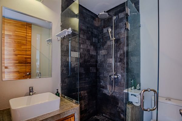 Modern walk-in shower with elegant tile finishes and glass enclosure.