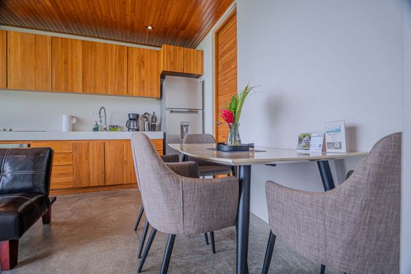 Dining area with comfortable seating, kitchen access, and thoughtful guest details.