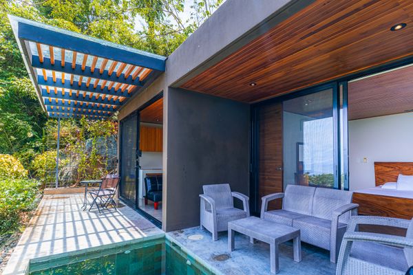 Covered terrace with outdoor seating and easy access to the villa.