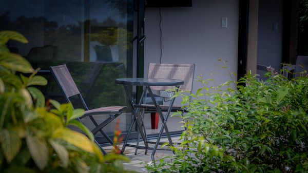 Enjoy quiet moments outdoors in a private dining area surrounded by nature.