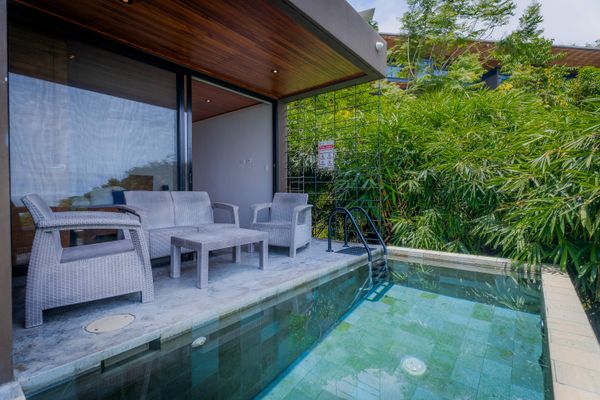 Poolside lounge area with comfortable seating and tropical surroundings.