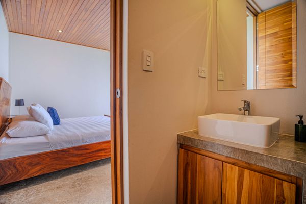 A clean and modern ensuite bathroom adds comfort and privacy to the bedroom.