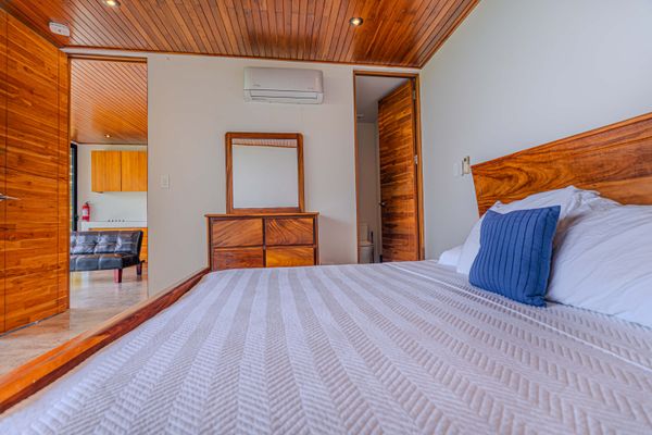 A comfortable bedroom with warm wood details and a calm, restful atmosphere.