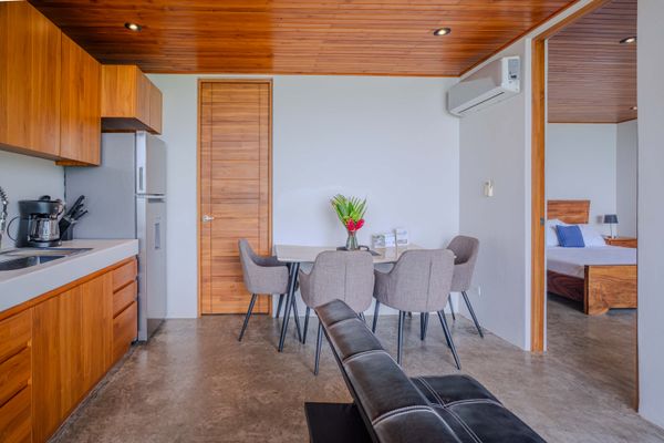 A cozy dining area with modern comforts and warm tropical design details.